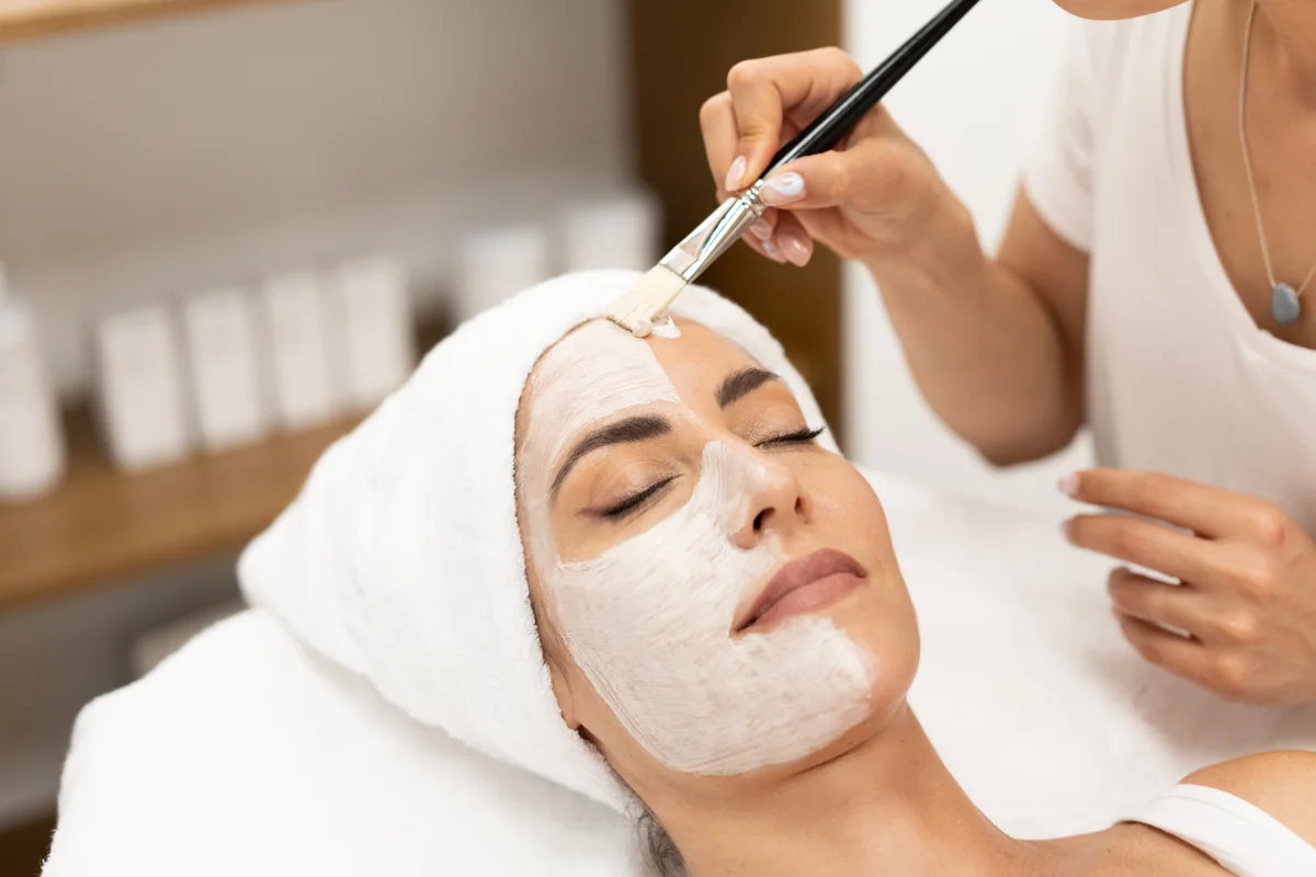 A licensed esthetician brushing on a BioRePeel chemical peel during a facial at SpaRx Medical Aesthetics in Thonotosassa, FL