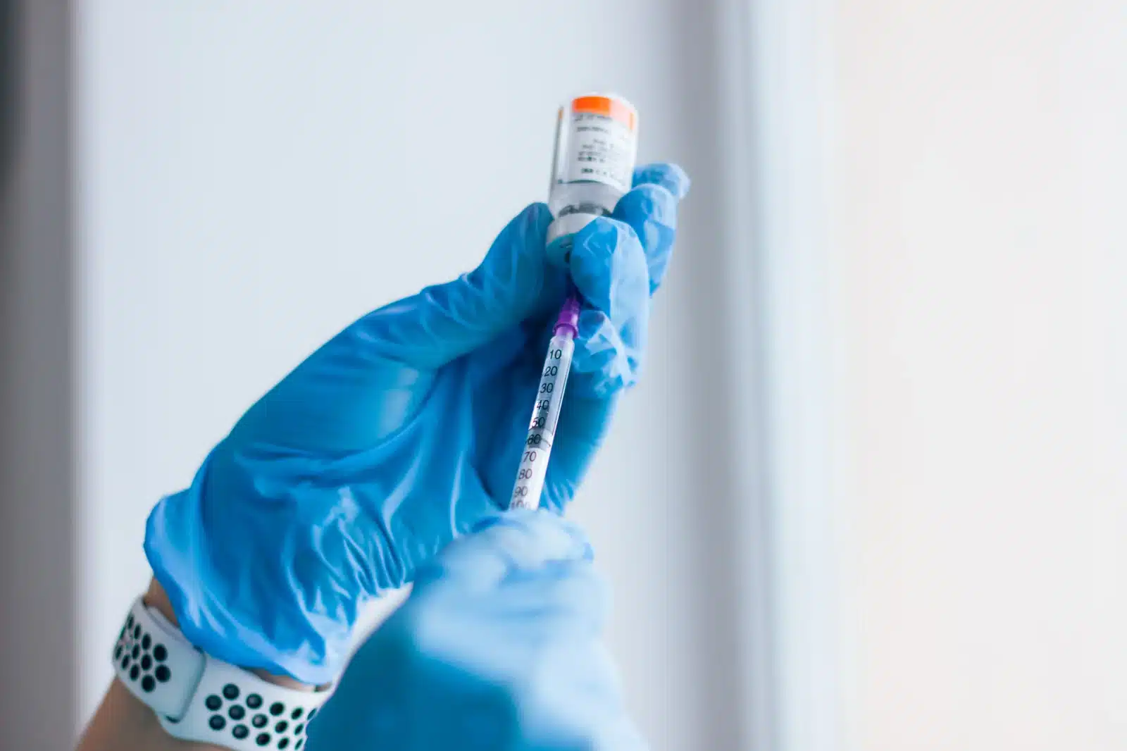 A certified injector preparing a syringe of dermal filler in a sterile glove at SpaRx Medical Aesthetics in Thonotosassa, FL.