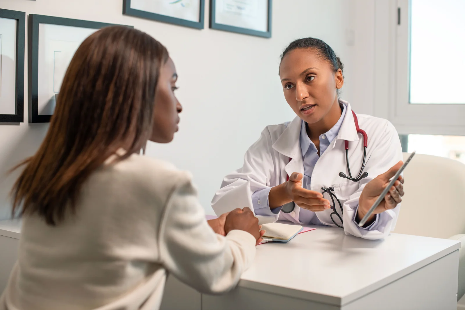 A physician discussing the benefits and risks of a medical weight loss plan with a patient at SpaRx Medical Aesthetics in Thonotosassa, FL.
