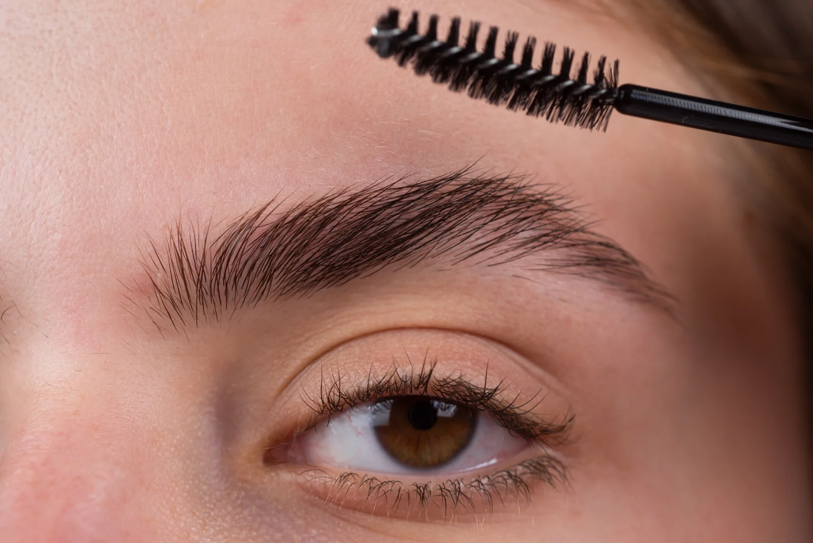 Healed, natural-looking brows being groomed after microblading at SpaRx Medical Aesthetics in Thonotosassa, FL