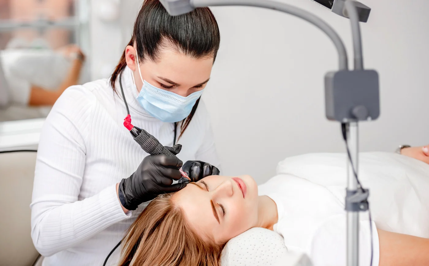 A certified permanent makeup artist defining a client's eyebrows at SpaRx Medical Aesthetics in Thonotosassa, FL.