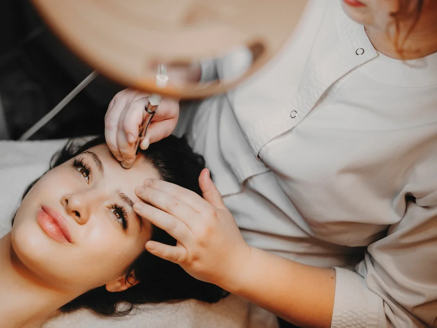 A licensed esthetician cleansing and prepping skin before LED light therapy at SpaRx Medical Aesthetics in Thonotosassa, FL